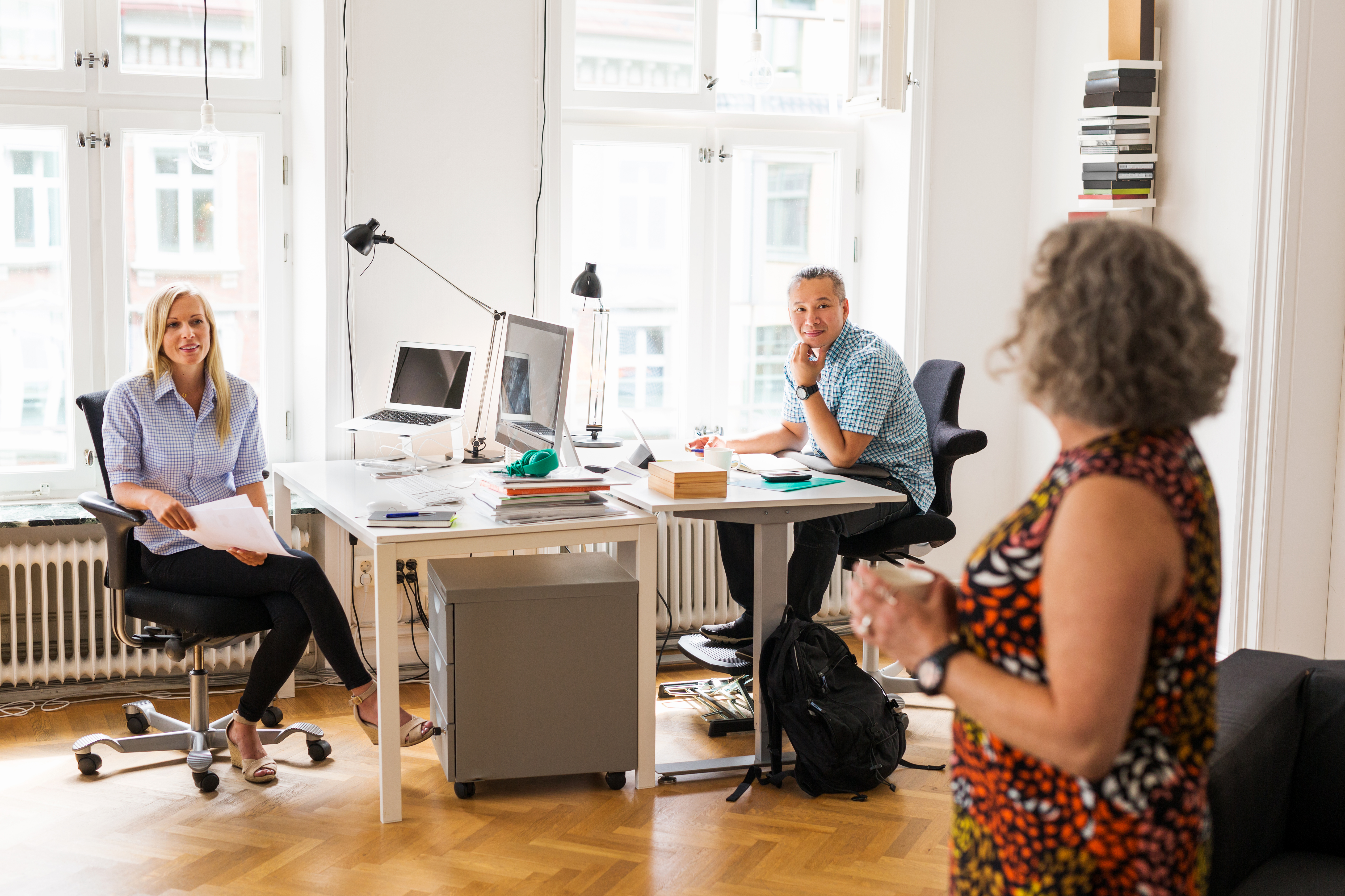 coworkers talking in office